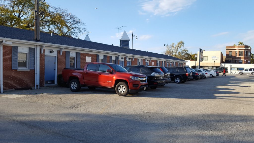 A photo of the front of the office building and parking