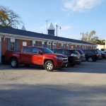A photo of the front of the office building and parking